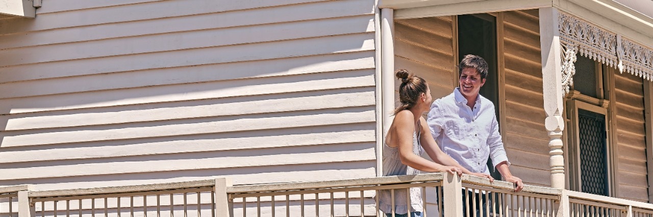 Young couple at house outside rural